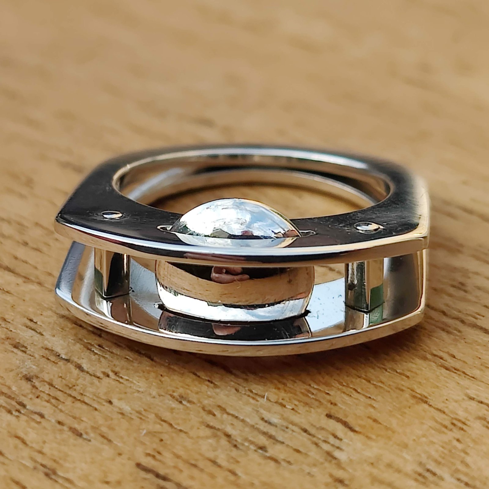 Polished sterling silver Suspension Ring exploring reflection and negative space